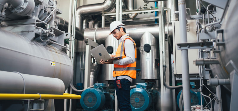 man doing PLC programmin on a laptop computer